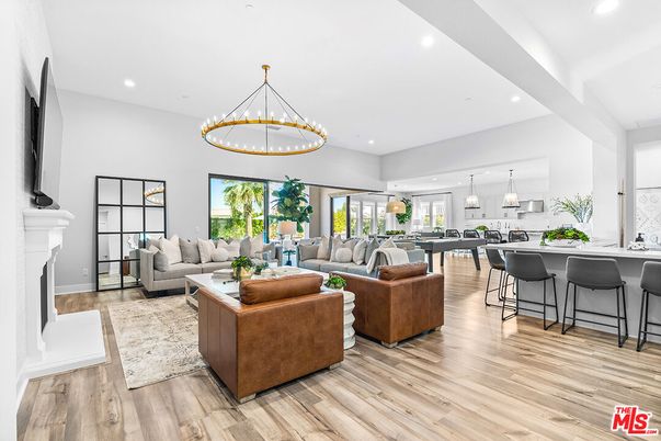 Chandelier, Dining room, Fireplace, Interior, Living room, Pendant Lights, Recessed Lighting, Wood Texture Flooring