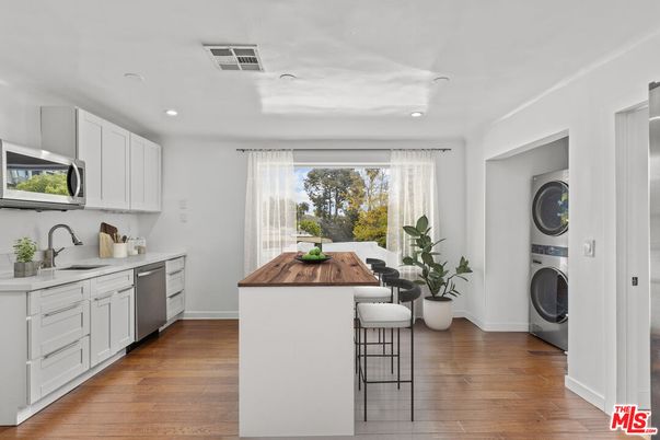 Interior, Kitchen, Recessed Lighting, Washer, Wood Texture Flooring