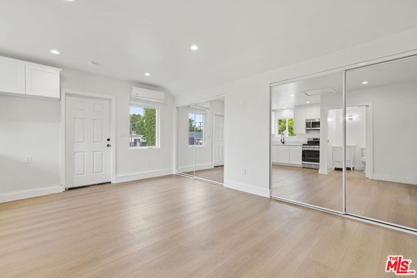 Empty room, Interior, Kitchen, Recessed Lighting, Stainless Steel Appliances, Wood Texture Flooring