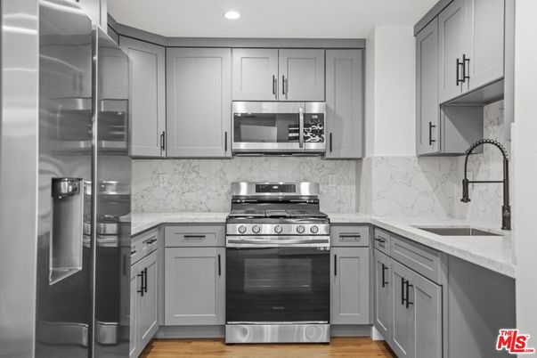 Interior, Kitchen, Marble Walls, Recessed Lighting, Stainless Steel Appliances, Wood Texture Flooring