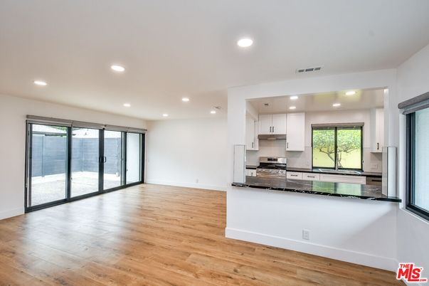 Empty room, Interior, Kitchen, Recessed Lighting, Stainless Steel Appliances, Wood Texture Flooring