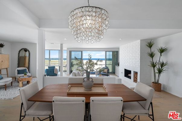Dining room, Fireplace, Interior, Living room, Recessed Lighting, Stone Walls, Water, Wood Texture Flooring