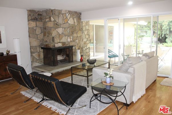 Fireplace, Interior, Living room, Recessed Lighting, Stone Walls, Wood Texture Flooring