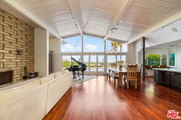 Dining room, Fireplace, Interior, Living room, Piano, Recessed Lighting, Stone Walls, Wood Texture Flooring