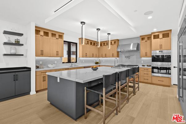 Interior, Kitchen, Marble Walls, Pendant Lights, Recessed Lighting, Stainless Steel Appliances, Wood Texture Flooring