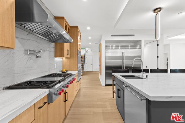 Interior, Kitchen, Marble Walls, Recessed Lighting, Stainless Steel Appliances, Wood Texture Flooring