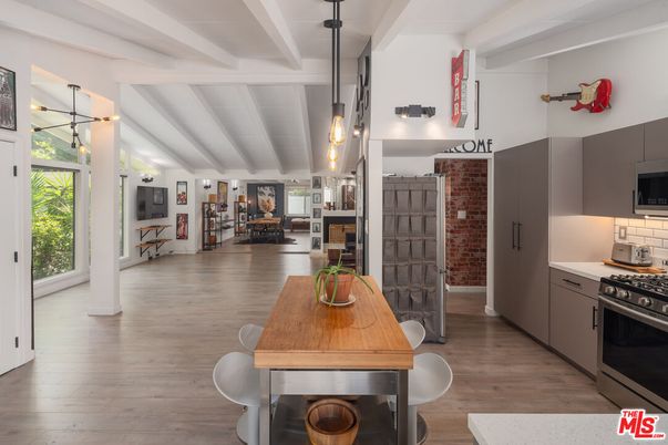 Dining room, Fireplace, Interior, Kitchen, Pendant Lights, Stainless Steel Appliances, Stone Walls, Wood Texture Flooring
