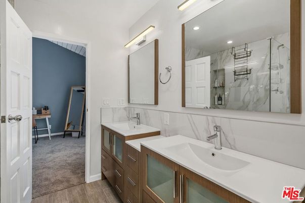 Bathroom, Dual Sink Vanities, Glass Shower, Interior, Marble Walls, Recessed Lighting, Wood Texture Flooring