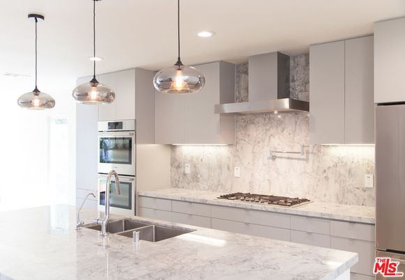 Interior, Kitchen, Marble Walls, Pendant Lights, Recessed Lighting, Stainless Steel Appliances