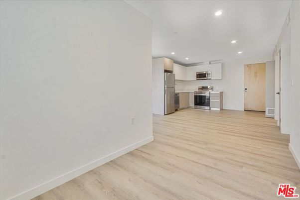 Empty room, Interior, Kitchen, Recessed Lighting, Stainless Steel Appliances, Wood Texture Flooring