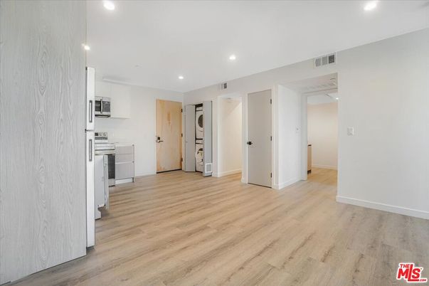Empty room, Interior, Kitchen, Recessed Lighting, Stainless Steel Appliances, Wood Texture Flooring
