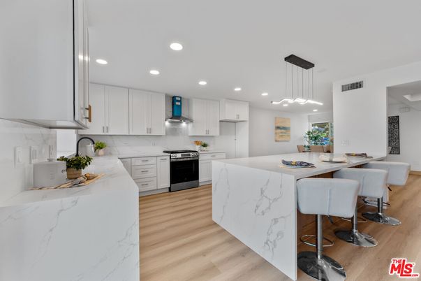 Interior, Kitchen, Marble Walls, Pendant Lights, Recessed Lighting, Stainless Steel Appliances, Wood Texture Flooring