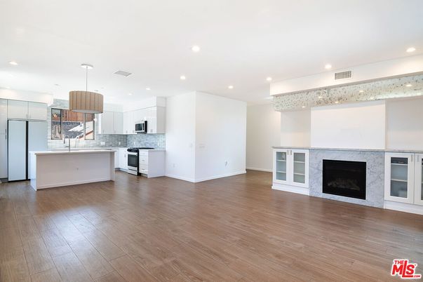 Empty room, Fireplace, Interior, Kitchen, Pendant Lights, Recessed Lighting, Wood Texture Flooring