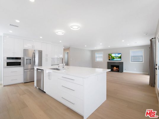 Fireplace, Interior, Kitchen, Recessed Lighting, Stainless Steel Appliances, Wood Texture Flooring