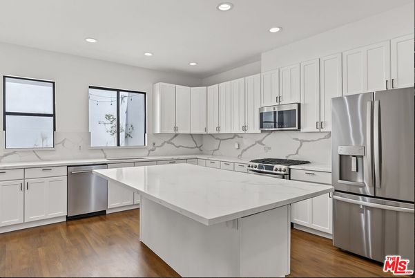 Interior, Kitchen, Marble Walls, Recessed Lighting, Stainless Steel Appliances, Wood Texture Flooring