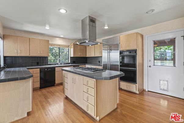 Interior, Kitchen, Recessed Lighting, Stainless Steel Appliances, Tile Countertops, Wood Texture Flooring