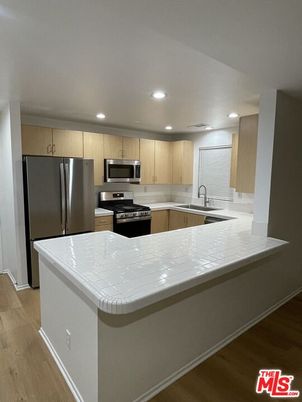 Interior, Kitchen, Recessed Lighting, Stainless Steel Appliances, Tile Countertops, Wood Texture Flooring