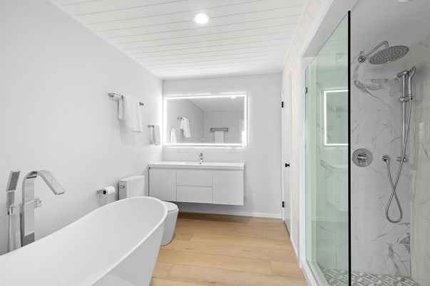 Bathroom, Dual Sink Vanities, Free Standing Baths, Glass Shower, Interior, Marble Walls, Recessed Lighting, Wood Texture Flooring