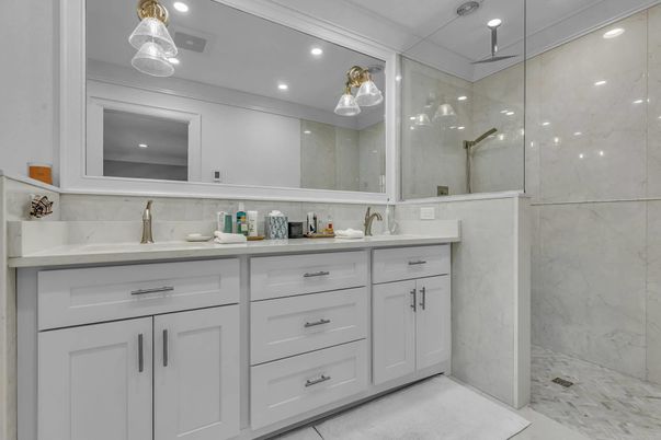 Bathroom, Dual Sink Vanities, Glass Shower, Interior, Marble, Marble Walls, Pendant Lights, Recessed Lighting