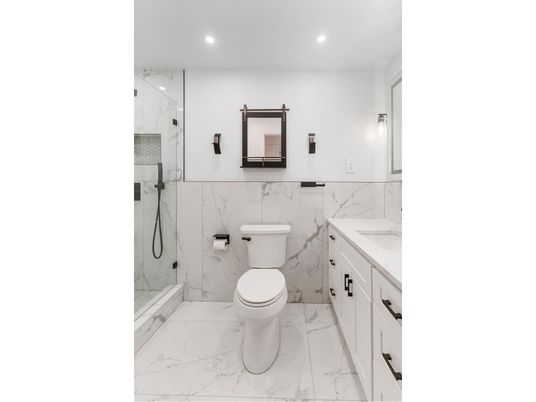 Bathroom, Dual Sink Vanities, Glass Shower, Interior, Marble, Marble Walls, Recessed Lighting