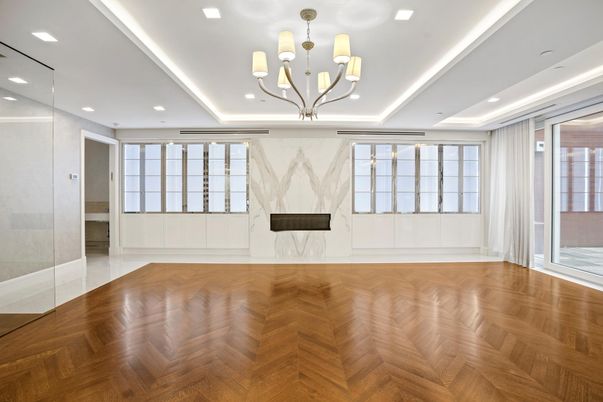 Chandelier, Empty room, Fireplace, Interior, Marble Walls, Recessed Lighting, Wood Texture Flooring