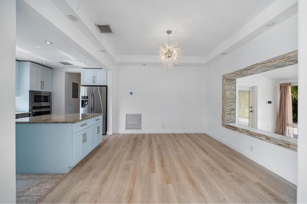 Chandelier, Empty room, Interior, Kitchen, Recessed Lighting, Stainless Steel Appliances, Wood Texture Flooring