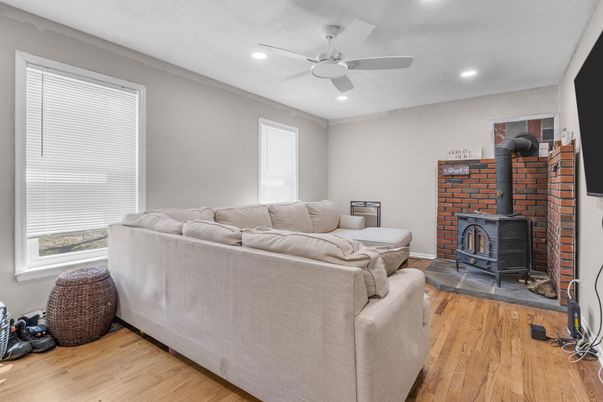 Fireplace, Interior, Living room, Recessed Lighting, Stone Walls, Wood Texture Flooring