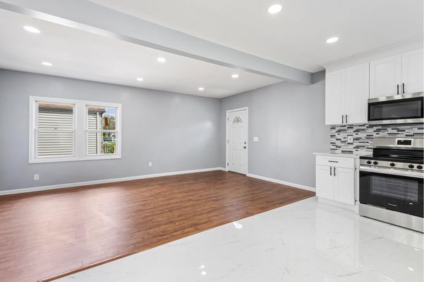 Empty room, Interior, Kitchen, Marble, Recessed Lighting, Stainless Steel Appliances, Wood Texture Flooring