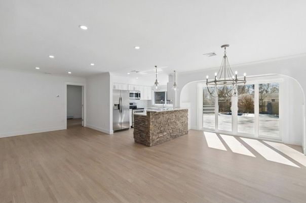 Chandelier, Empty room, Interior, Kitchen, Pendant Lights, Recessed Lighting, Stainless Steel Appliances, Wood Texture Flooring
