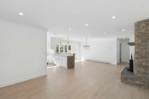 Chandelier, Empty room, Fireplace, Interior, Pendant Lights, Recessed Lighting, Stone Walls, Wood Texture Flooring