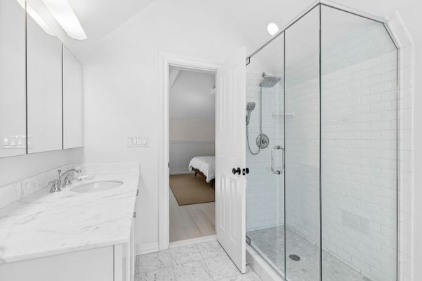 Bathroom, Dual Sink Vanities, Glass Shower, Interior, Marble, Wood Texture Flooring