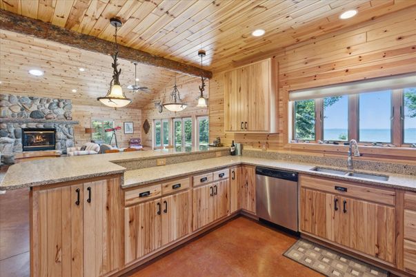 Fireplace, Interior, Kitchen, Pendant Lights, Recessed Lighting, Stainless Steel Appliances, Stone Walls, Water, Wooden Ceilings, Wooden Walls