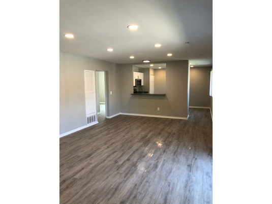 Empty room, Interior, Kitchen, Recessed Lighting, Stainless Steel Appliances, Wood Texture Flooring