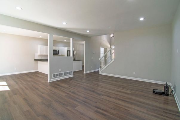 Empty room, Interior, Kitchen, Recessed Lighting, Stainless Steel Appliances, Wood Texture Flooring