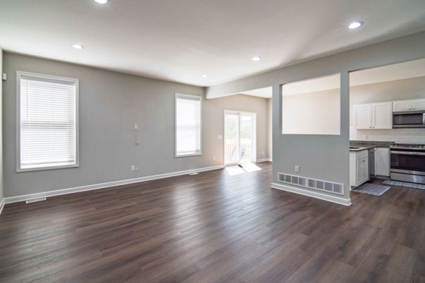 Empty room, Interior, Kitchen, Recessed Lighting, Stainless Steel Appliances, Wood Texture Flooring