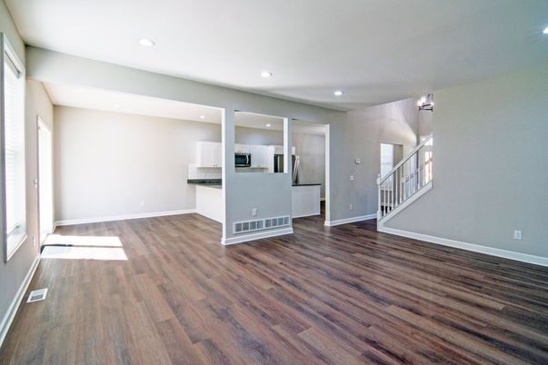 Empty room, Interior, Kitchen, Recessed Lighting, Stainless Steel Appliances, Wood Texture Flooring