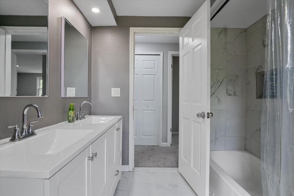 Bathroom, Dual Sink Vanities, Glass Shower, Interior, Marble, Marble Walls, Recessed Lighting