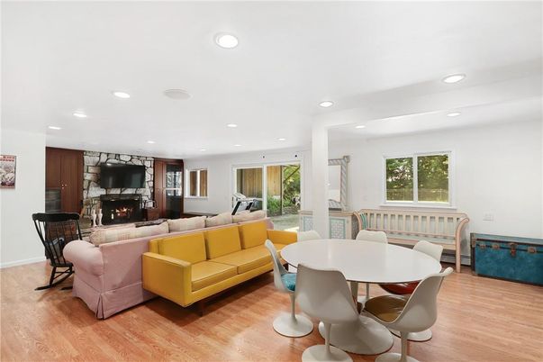Dining room, Fireplace, Interior, Living room, Recessed Lighting, Stone Walls, Wood Texture Flooring