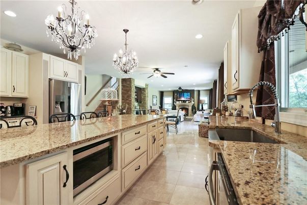 Chandelier, Dining room, Fireplace, Interior, Kitchen, Living room, Recessed Lighting, Stainless Steel Appliances, Stone Walls