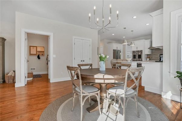Chandelier, Dining room, Interior, Kitchen, Pendant Lights, Recessed Lighting, Stainless Steel Appliances, Wood Texture Flooring