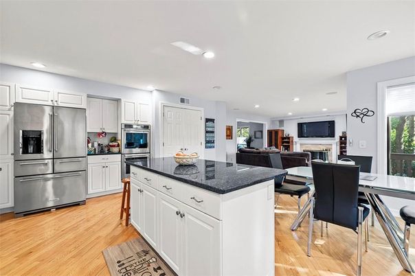 Dining room, Fireplace, Interior, Kitchen, Living room, Recessed Lighting, Stainless Steel Appliances, Wood Texture Flooring