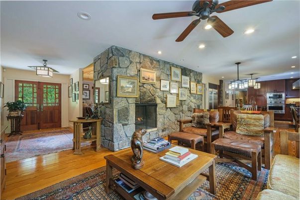 Fireplace, Interior, Kitchen, Living room, Pendant Lights, Recessed Lighting, Stainless Steel Appliances, Stone Walls, Wood Texture Flooring