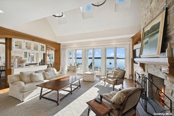 Fireplace, Interior, Living room, Recessed Lighting, Stone Walls, Water, Wood Texture Flooring