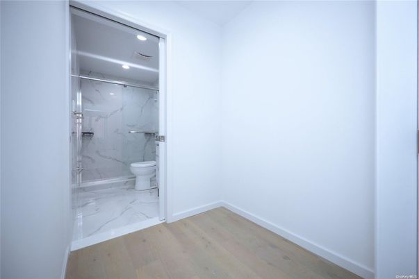 Bathroom, Glass Shower, Interior, Marble, Marble Walls, Recessed Lighting, Wood Texture Flooring