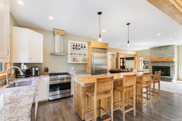 Fireplace, Interior, Kitchen, Pendant Lights, Recessed Lighting, Stainless Steel Appliances, Stone Walls, Wood Texture Flooring