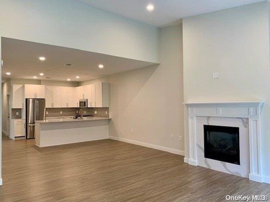 Fireplace, Interior, Kitchen, Recessed Lighting, Stainless Steel Appliances, Wood Texture Flooring