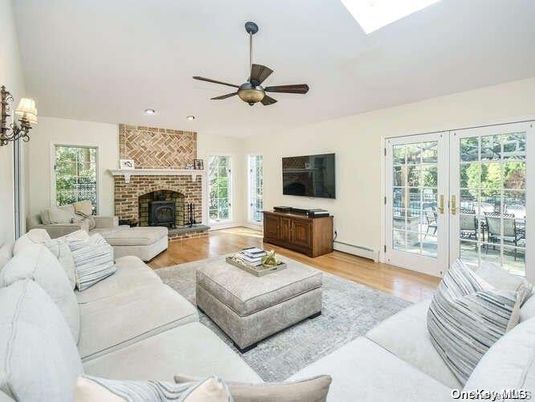 Fireplace, Interior, Living room, Recessed Lighting, Stone Walls, Wood Texture Flooring