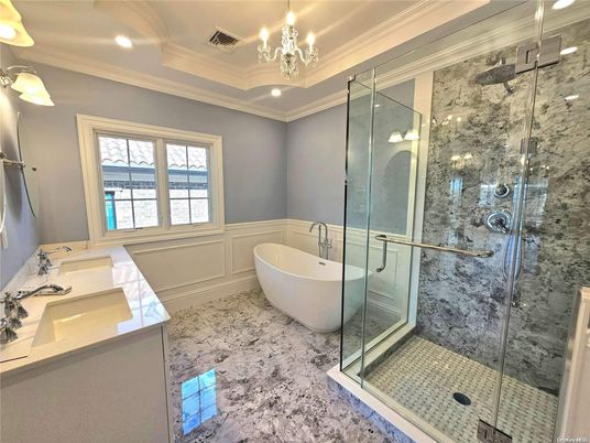 Bathroom, Chandelier, Dual Sink Vanities, Free Standing Baths, Glass Shower, Interior, Marble, Marble Walls, Recessed Lighting