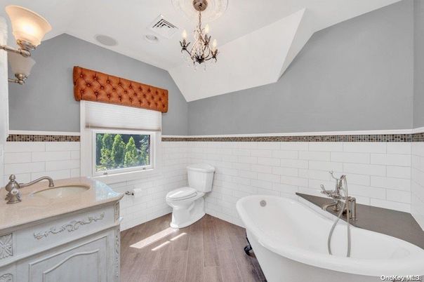 Bathroom, Chandelier, Dual Sink Vanities, Free Standing Baths, Interior, Wood Texture Flooring