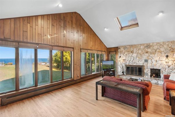 Fireplace, Interior, Living room, Recessed Lighting, Stone Walls, Water, Wood Texture Flooring, Wooden Walls